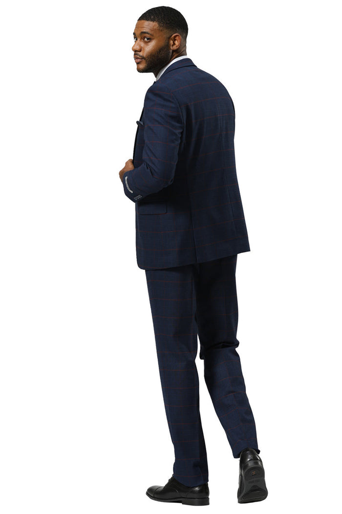 Navy Stacy Adams suit with a glen plaid pattern, peak lapel, and a double-breasted vest. Features structured shoulders, slim-fit trousers, and a single back vent. Textured fabric.
