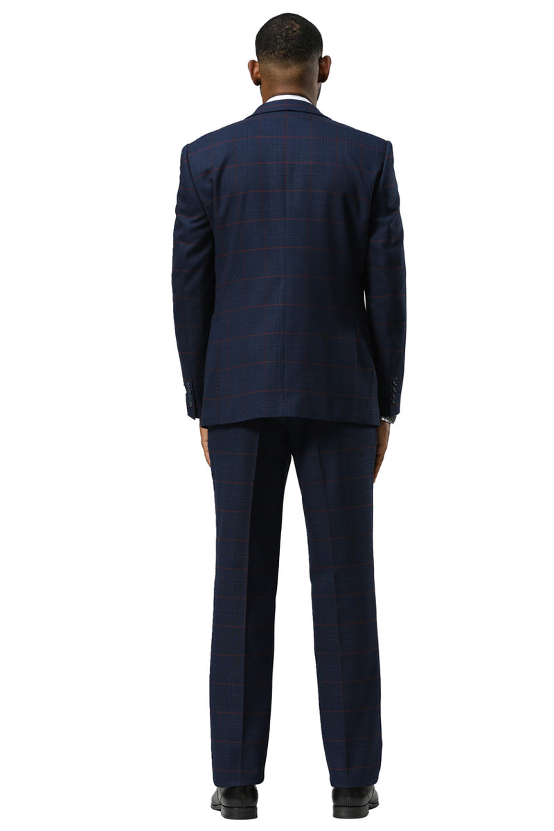 Navy glen plaid suit: one-button peak lapel jacket, structured fit, flat-front trousers. Navy/red check pattern. Single vent jacket, double-breasted vest. Classic, tailored look.
