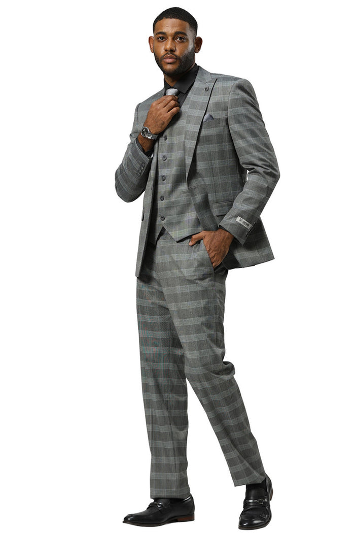 Grey glen plaid Stacy Adams suit. One-button jacket with peak lapels, structured shoulders, and matching vest. Straight-cut trousers complete the fitted silhouette.
