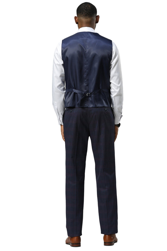 Navy glen plaid Stacy Adams suit. One-button peak lapel. Includes vest with adjustable back and contrasting white shirt. Matching trousers in a slightly different shade. Structured shoulders.
