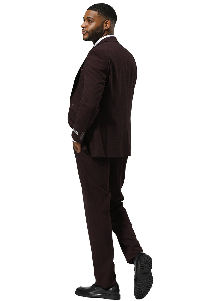 Burgundy Stacy Adams men's sharkskin suit. One-button blazer with peak lapel, vest, and matching trousers. Fitted shape, subtle sheen, and uniform color/texture. Styled cohesively.
