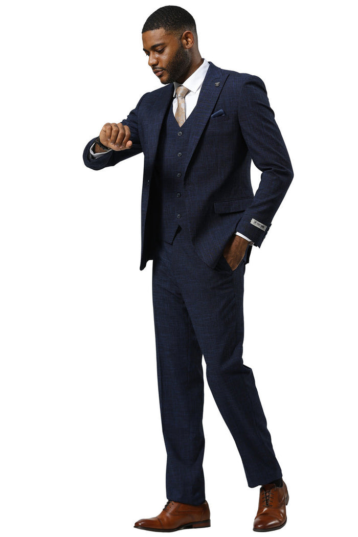 Navy sharkskin men's suit by Stacy Adams. One-button peak lapel jacket, vest, and trousers. Textured pattern, fitted silhouette, straight leg pants. Sleek and well-structured.
