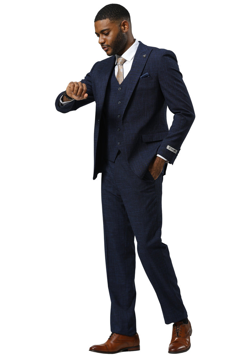 Navy sharkskin men's suit by Stacy Adams. One-button peak lapel jacket, vest, and trousers. Textured pattern, fitted silhouette, straight leg pants. Sleek and well-structured.
