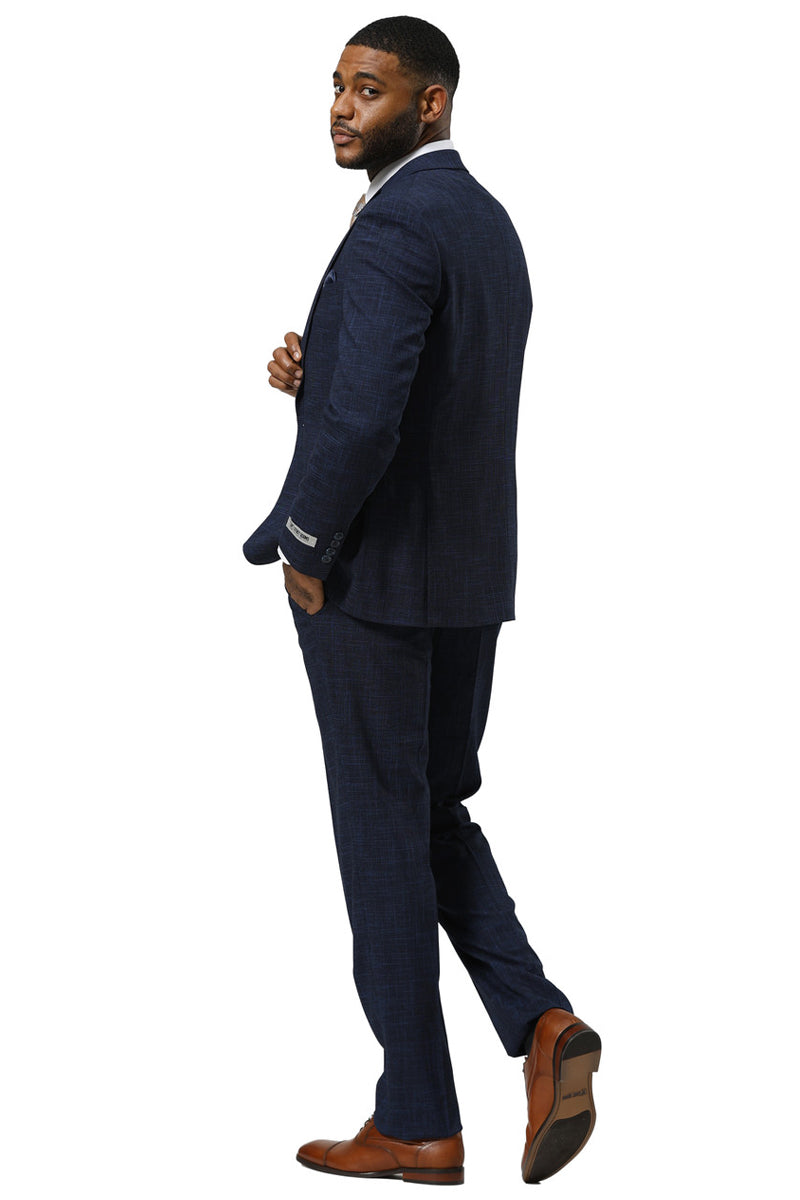 Navy Stacy Adams men's sharkskin suit. One-button, peak lapel, and fitted. Includes a vest and straight-leg trousers. Smooth, textured fabric with a subtle sheen.
