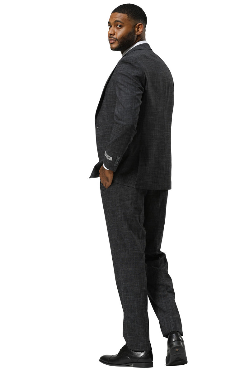 Stacy Adams charcoal sharkskin suit. One-button, peak lapel, vested. Fitted silhouette with textured fabric and subtle sheen. Blazer and straight-leg trousers.
