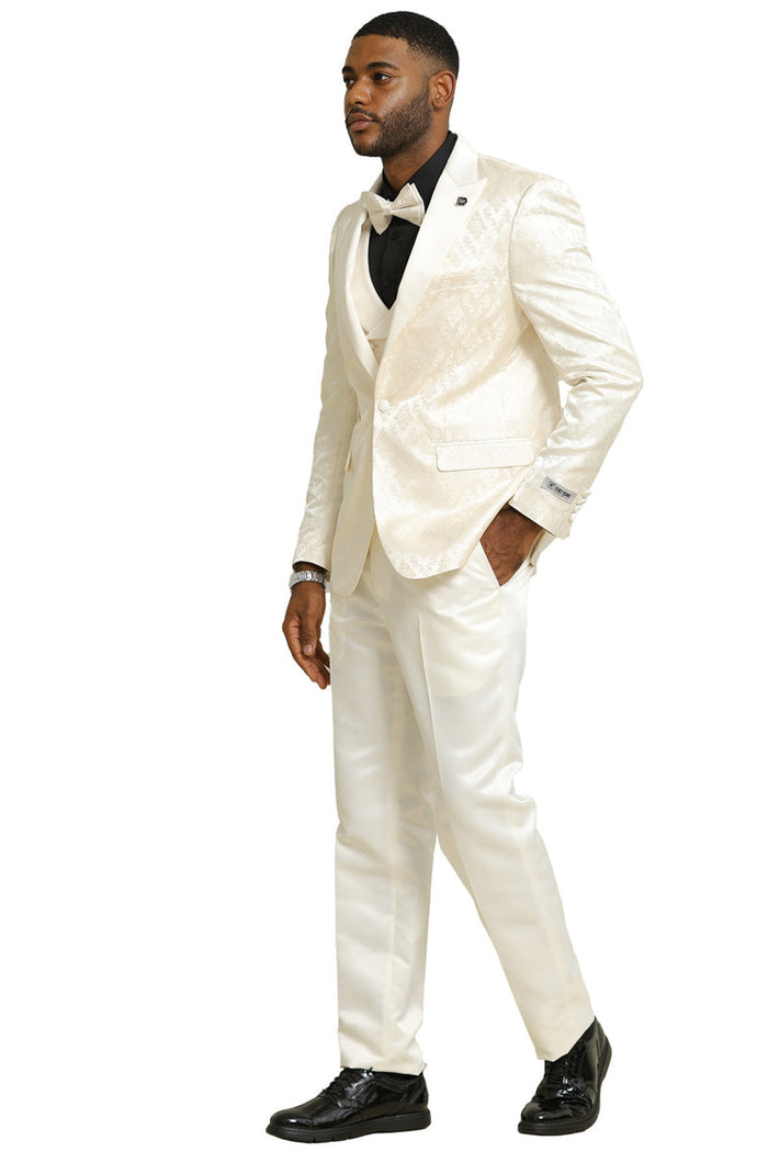 Stacy Adams ivory tuxedo with shiny brocade fabric. Includes double-breasted vest, fitted jacket, tailored trousers, satin lapels, black shirt, and bow tie. Perfect for weddings and proms.
