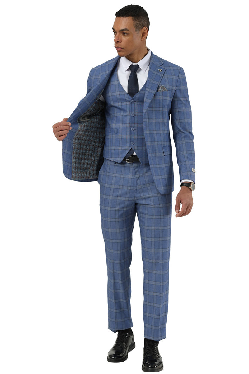 Blue Stacy Adams glen plaid suit. Fitted, three-button blazer with notch lapels, matching vest and straight-cut trousers. Contrasting plaid pattern. Blazer lined with patterned fabric. Includes white shirt and navy tie.
