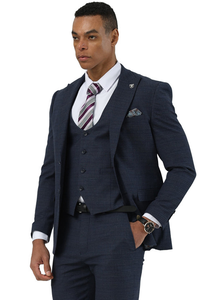 Stacy Adams men's navy glen plaid suit. Two-button peak lapel jacket with dual flap pockets, scoop vest, and coordinated trousers. Structured, fitted silhouette with textured fabric.
