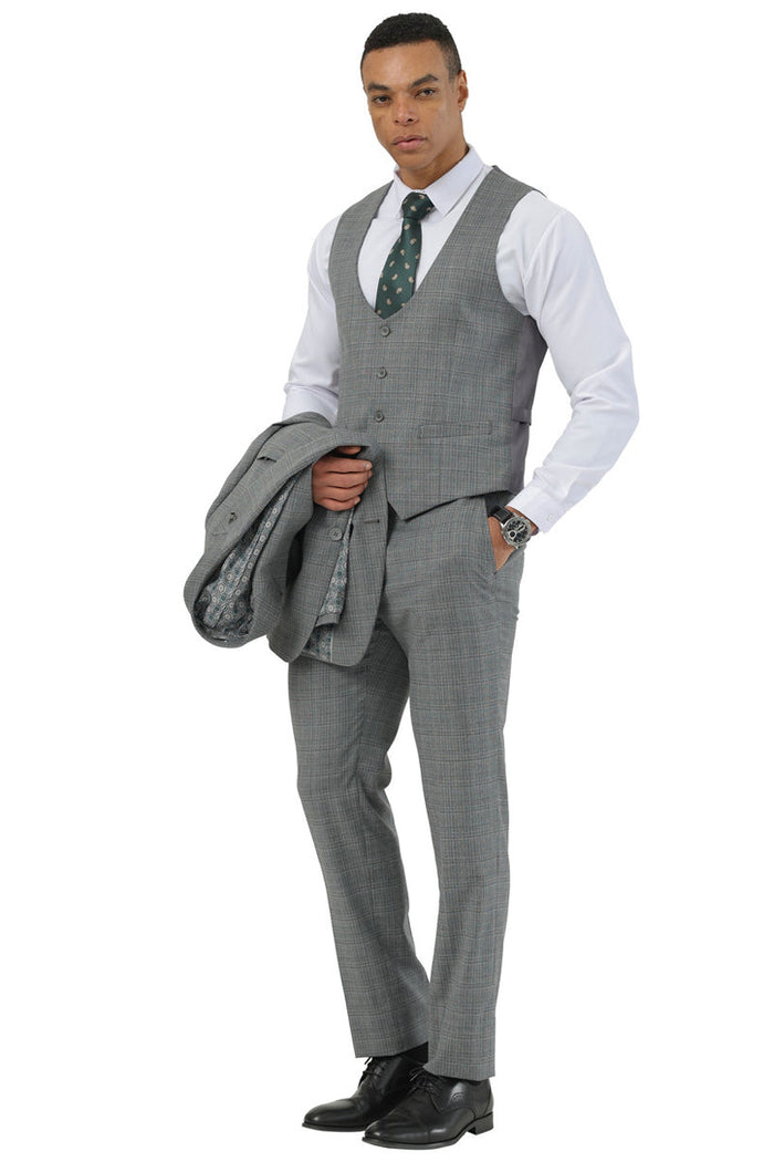 Stacy Adams men's three-piece suit in grey glen plaid. Features a two-button jacket with peak lapel, matching scoop vest, and tailored pants. Modern, fitted silhouette. Grey with subtle plaid pattern.
