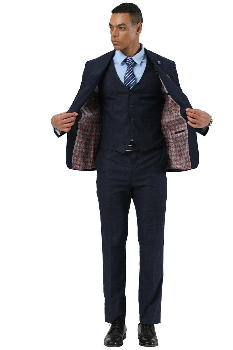 Navy Stacy Adams suit: sharkskin weave, tailored jacket (two-button, patterned lining), matching vest, slim-fit trousers. Polished black shoes complete the classic look.
