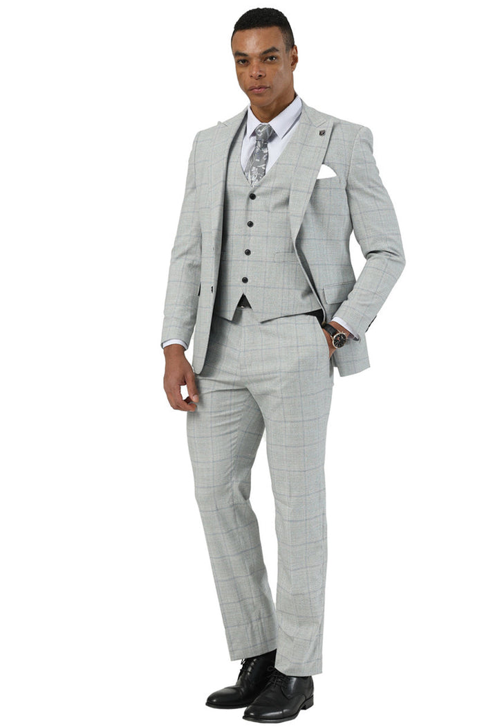 Light grey Stacy Adams men's suit. Two-button, peak lapel jacket, vest, and tailored trousers. Windowpane plaid pattern. Smooth, lightweight fabric. Close-fitting cut.
