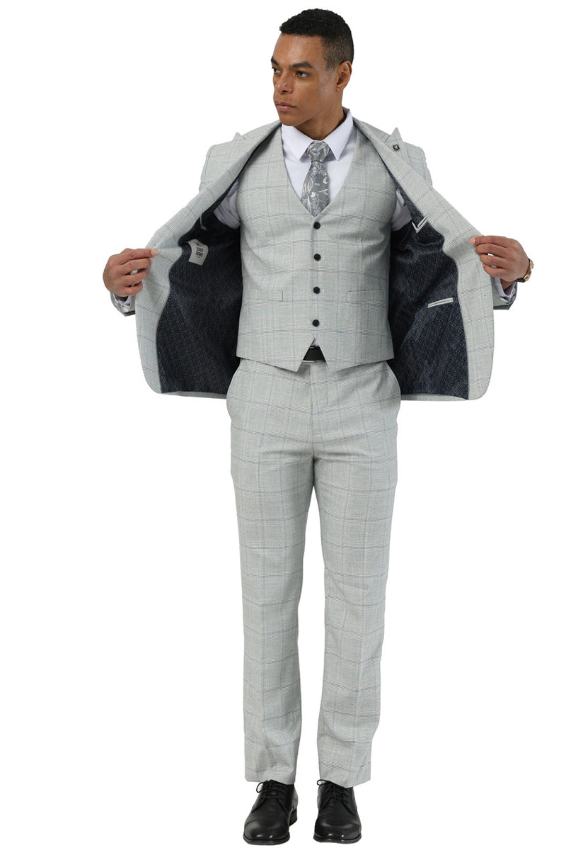 Men's Stacy Adams light grey two-button suit with windowpane plaid. Peak lapel, matching vest, and straight-leg trousers. Contrasting lining in jacket.
