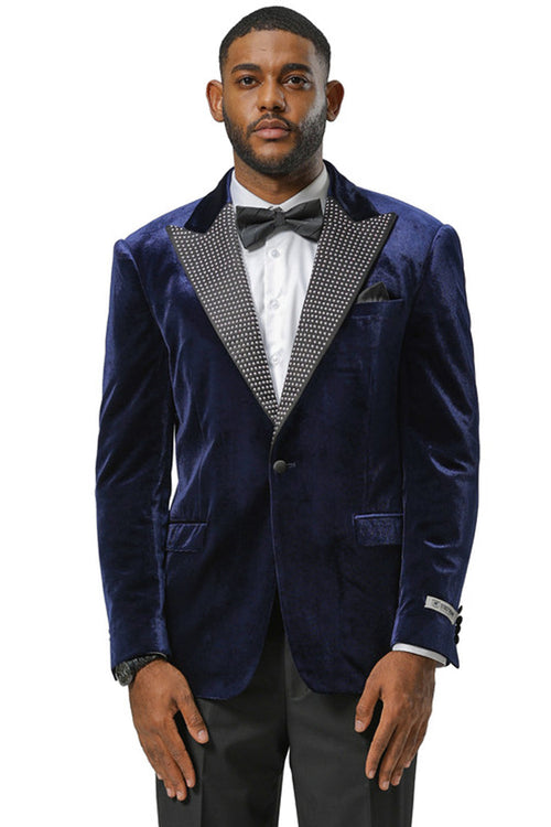 Navy velvet tuxedo jacket for men. Features rhinestone lapel, tailored fit, single-button closure, and decorative sleeve buttons. Includes two front pockets.
