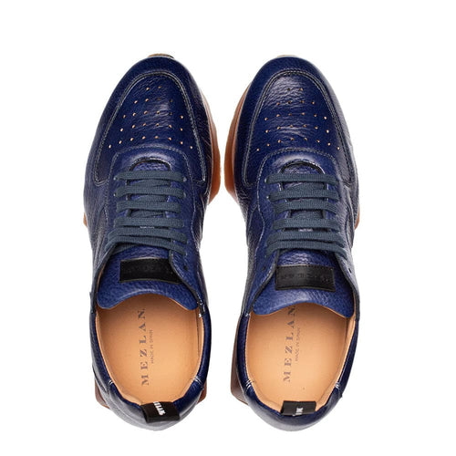 Mezlan Gerardo men's sneakers. Blue deerskin upper with perforations. Rounded toe, low-profile. Blue laces, tan leather lining, and brown rubber outsole for contrast.
