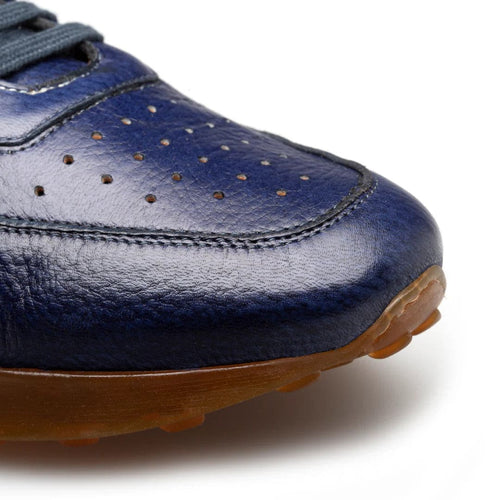 Men's Gerardo blue deerskin sneakers: navy upper with perforated detailing, rounded toe, and brown rubber sole. Dark laces complete the design.
