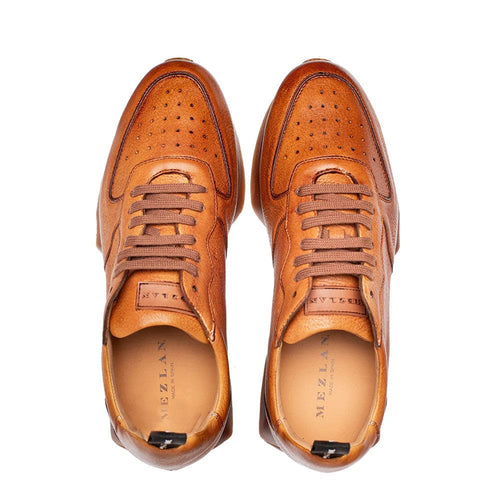 Gerardo men's cognac deerskin sneakers: rounded toe, perforated vamp, lace-up closure with brown laces, black heel pull tab. Matching sole.
