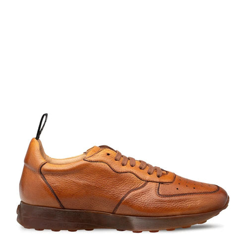 Mezlan Gerardo cognac deerskin sneakers for men. Streamlined silhouette, rounded toe, and stitched detailing. Cognac deerskin upper with perforations for breathability, dark brown rubber sole, and heel pull tab.
