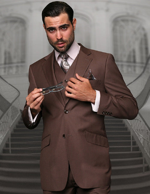 Men's modern fit suit in coco brown wool blend. Two-button closure, includes vest. Structured lapels, front pockets, detailed pocket square. Tailored fit for a sharp look.
