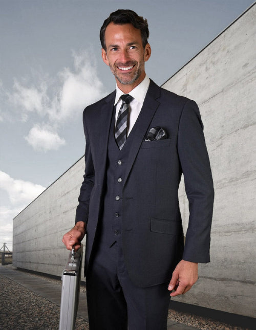 Men's modern fit denim blue wool suit. Features a 2-button jacket, notched lapel, two front pockets, and a matching vest. Sleek and consistent denim blue.