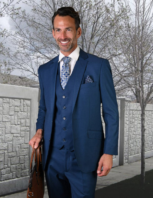Modern fit men's suit in French Blue. 2-button jacket, notched lapel, and 5-button vest. Made of wool with a solid color. Includes matching trousers. Sleek, tailored design.