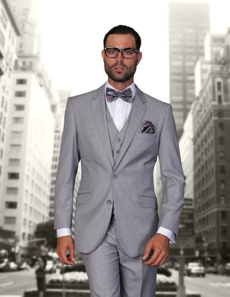 Grey wool modern fit suit. Two-button jacket, matching vest. Tailored lapels, front pockets. Fitted silhouette, precise trouser fit. Classic and sharp.
