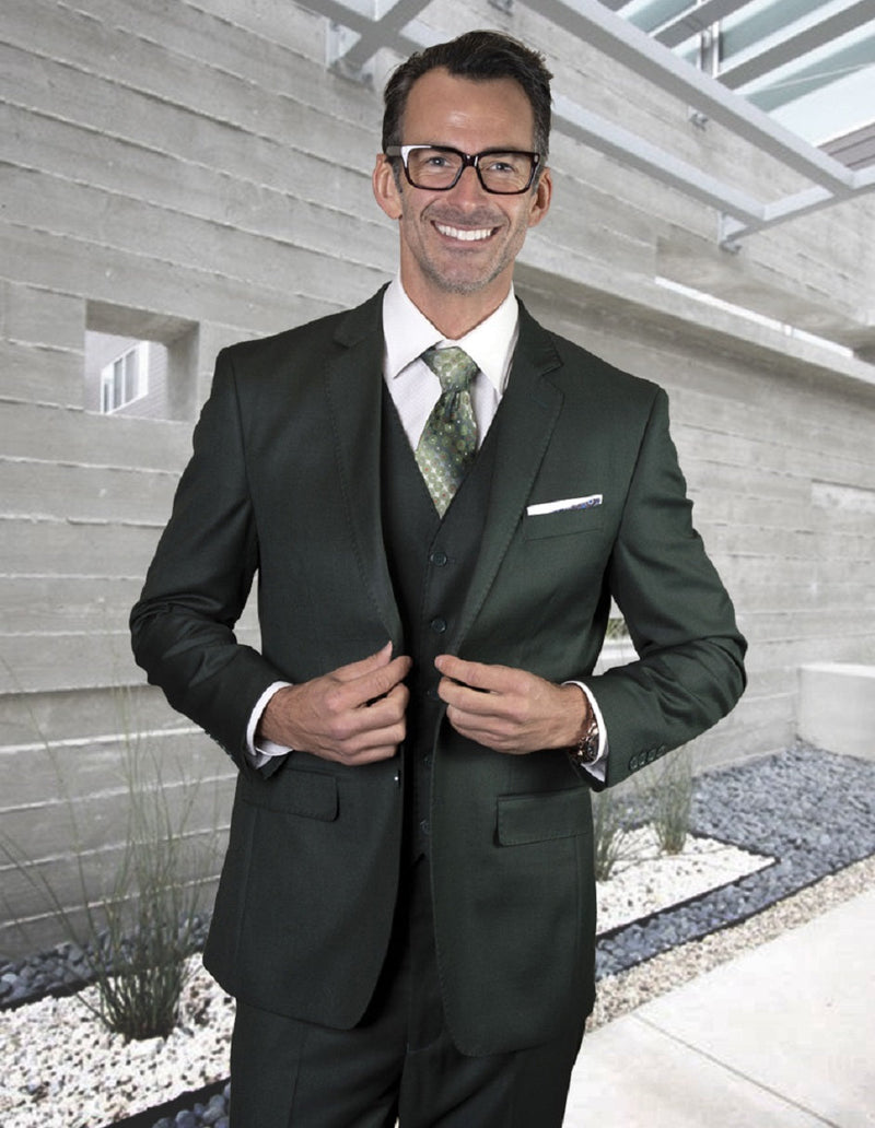 Hunter Green modern fit suit with vest. Two-button closure, pick stitch details, and a tailored silhouette. Smooth fabric for a sleek, rich appearance.
