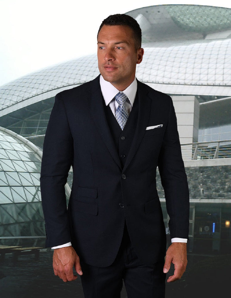 Men's modern fit navy blue vested suit with pick stitching. Features a structured, tailored blazer with notch lapels and dual pockets. Vest included for a cohesive look. Slight fabric sheen.
