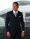 Men's modern fit navy blue vested suit with pick stitching. Features a structured, tailored blazer with notch lapels and dual pockets. Vest included for a cohesive look. Slight fabric sheen.
