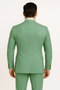 Men's sage green double-breasted suit. Tailored fit with strong shoulders & fitted rear. Smooth fabric, gold buttons on jacket sleeves.
