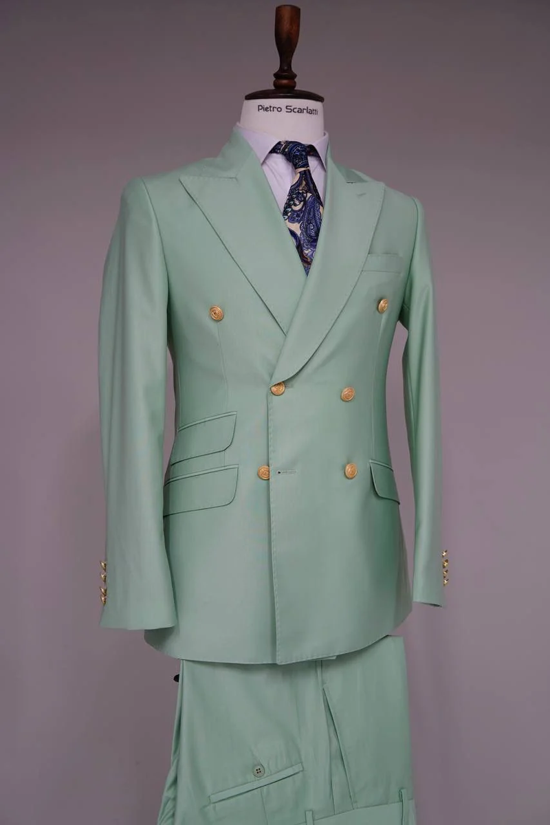 Sage green double-breasted men's suit. Features gold buttons, tailored fit, peak lapel, side pockets, and matching trousers. Elegant and stylish.
