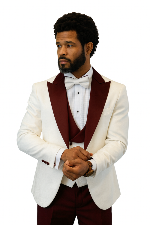 White tuxedo jacket with burgundy peak lapel, matching vest & wool pants. Includes bow tie. Textured jacket. Sophisticated ensemble.
