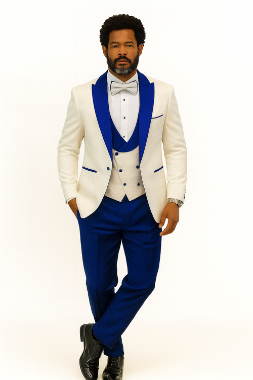 White tuxedo jacket with royal blue peak lapels. Includes matching shawl vest, wool pants, and bow tie. Structured form with contrasting colors and embroidered details.
