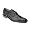 Men's Belvedere Siena black moc toe dress shoe. Crafted from glossy black ostrich leg leather, featuring a textured pattern, lace-up detail, and a structured design. Finished with a black leather sole.
