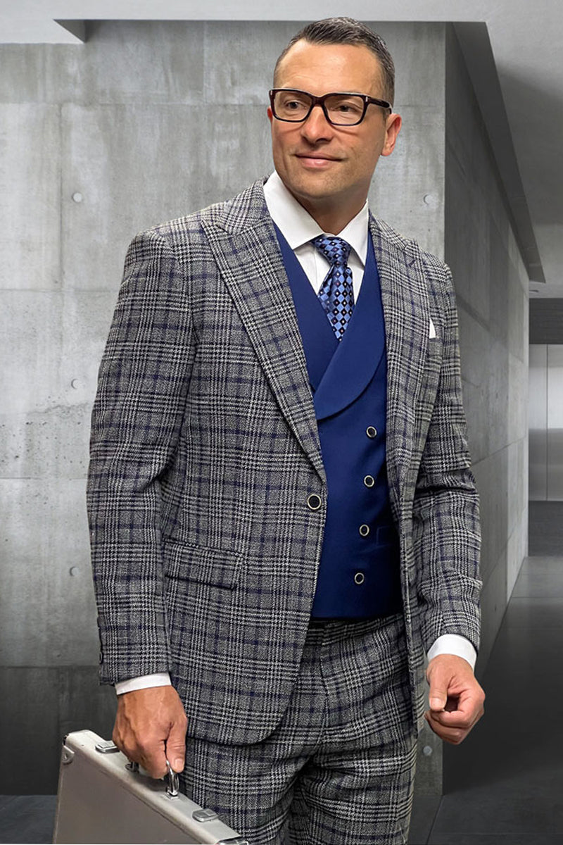 Men's designer wool suit. Grey glenplaid pattern. Tailored jacket with notch lapels, fitted vest, and matching trousers. Dark grey shades with blue interior accents. Structured, formal appearance.
