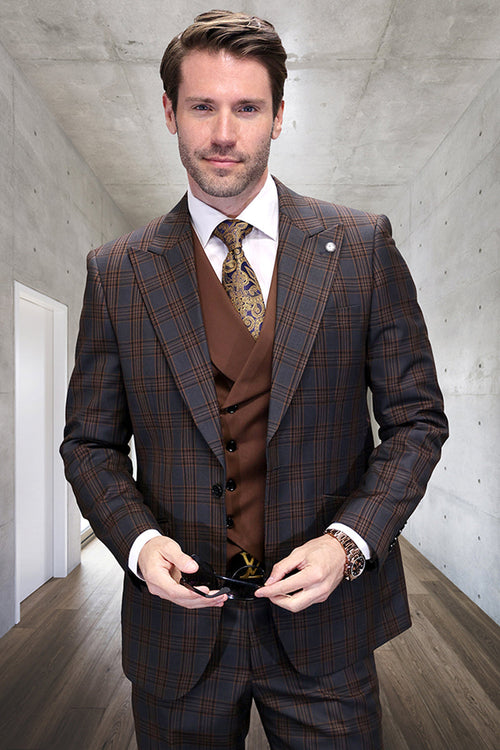 Men's charcoal grey wool vested suit with a one-button jacket and peak lapels. Features a windowpane plaid pattern (brown/blue), structured shoulders, fitted tailoring, and a 3-button vest. Worn with a white dress shirt.