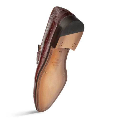 Men's burgundy alligator penny loafers. Structured shape, low vamp, rounded toe. Genuine alligator upper with distinct scale patterns. Leather sole with decorative punch holes and a slightly raised heel.
