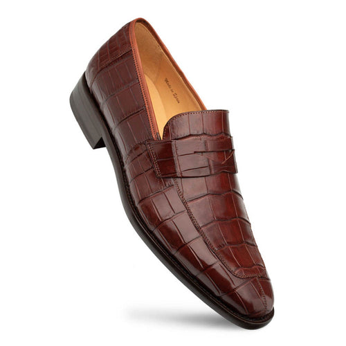 Men's dark brown alligator penny loafers with a tapered shape and flat sole. Genuine American alligator leather features a textured pattern. Includes a penny slot detail. Lighter interior lining.
