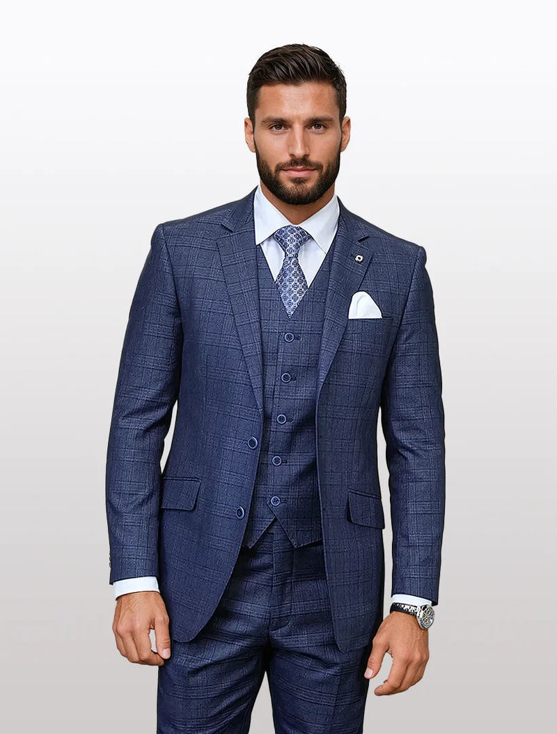 Mens indigo windowpane plaid modern fit vested suit by Alberto Nardoni features a tailored jacket with a notched lapel and two buttons. The fabric is 100% wool, showcasing a subtle plaid pattern. The vest has a five-button closure, and the suit is paired with matching trousers.