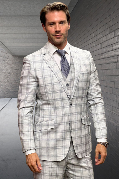 Tan wool suit with double windowpane plaid. Fitted blazer: notch lapels, 3-button closure. Matching vested trousers. Light tan base, darker tan checks. Designer menswear.