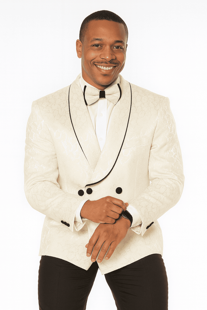 Men's champagne wedding tuxedo with paisley pattern. Includes double-breasted jacket, white shirt & black bow tie. Light beige suit with black trim, fitted dark pants.
