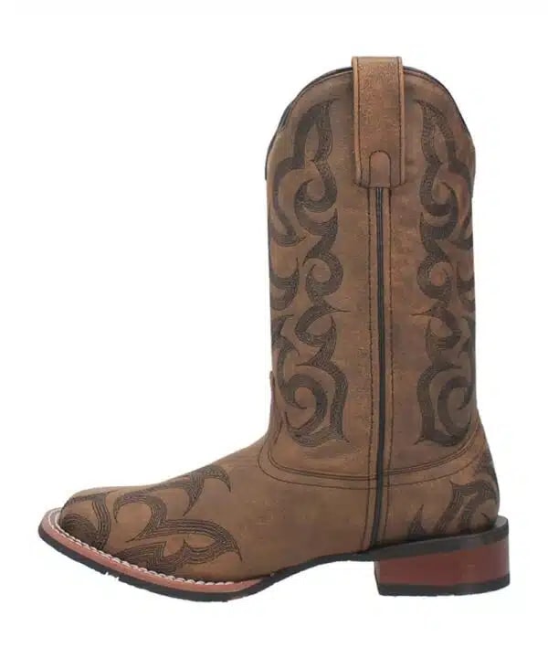 Laredo Sariah women's boot: Tall, tan, textured shaft with pointed toe and slight heel. Dark brown stitched swirling pattern. Pull tab and durable sole.
