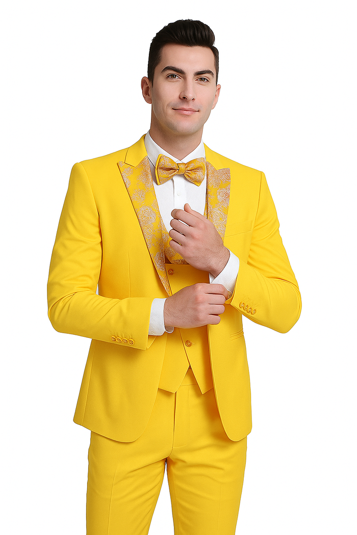 Vivid yellow men's three-piece suit with floral peak lapel and matching bow tie. Includes jacket, waistcoat, and tailored trousers. Smooth, slightly shiny material. Structured shoulders & front-fastening waistcoat.
