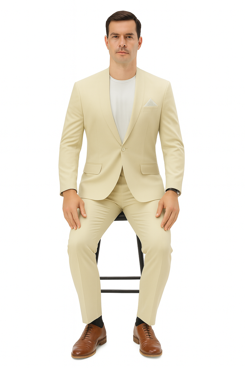 Men's light beige linen suit with a relaxed fit. Collarless blazer, single-button closure, and matching trousers. Worn with a white shirt, pocket square, and brown dress shoes.
