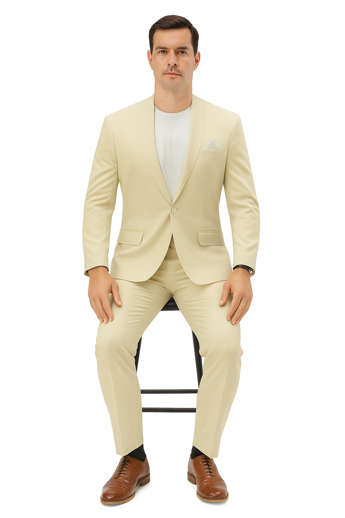 Men's light beige linen suit with a relaxed fit. Collarless blazer, single-button closure, and matching trousers. Worn with a white shirt, pocket square, and brown dress shoes.
