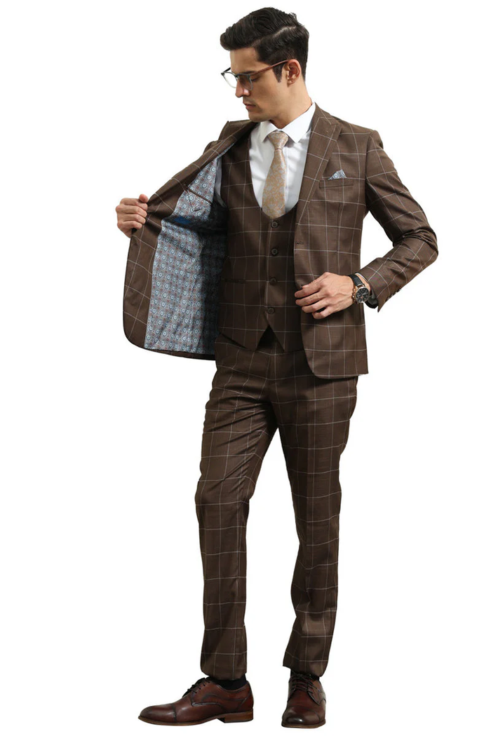 Men's slim fit brown windowpane plaid suit. Peak lapel, two-button closure, and vested. Includes a fitted blazer and matching trousers. Features contrasting blue patterned interior lining.
