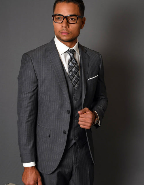 Modern fit charcoal grey pinstripe wool suit. Two-button jacket, vest included. Wool blend with a tailored silhouette, notch lapels, and side pockets. Stylish and fitted.

