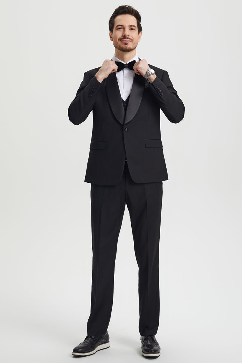 Stacy Adams men's black one-button tuxedo with shawl lapel. Fitted jacket, flat-front trousers, and a structured silhouette. Features smooth, solid black fabric and satin details.
