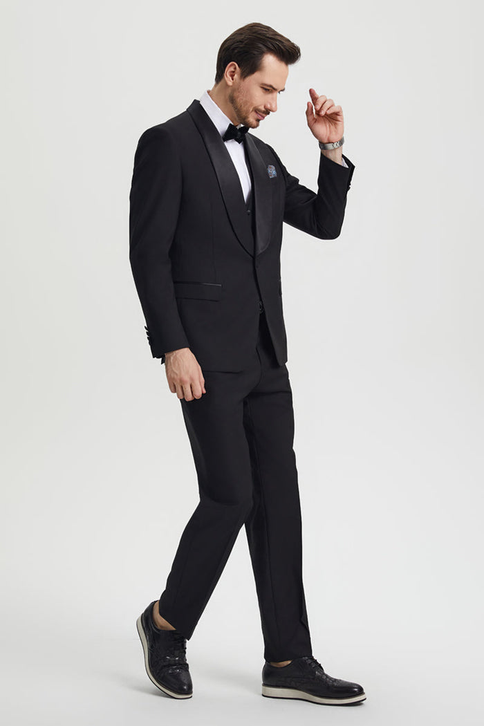 Stacy Adams men's black one-button tuxedo with shawl lapel. Fitted silhouette includes a vest. Features matching straight-cut trousers and sleek black shoes. Smooth fabric.
