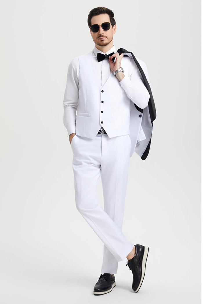 Stacy Adams white tuxedo: one-button jacket with shawl lapel. Fitted vest with black buttons. White, straight-leg trousers. Includes black bow tie. Formal attire.

