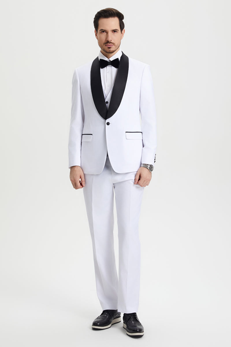 White Stacy Adams one-button tuxedo with black satin shawl lapel. Fitted, smooth fabric. Includes matching trousers, minimal black detailing, white shirt, and black bow tie. Paired with black shoes.
